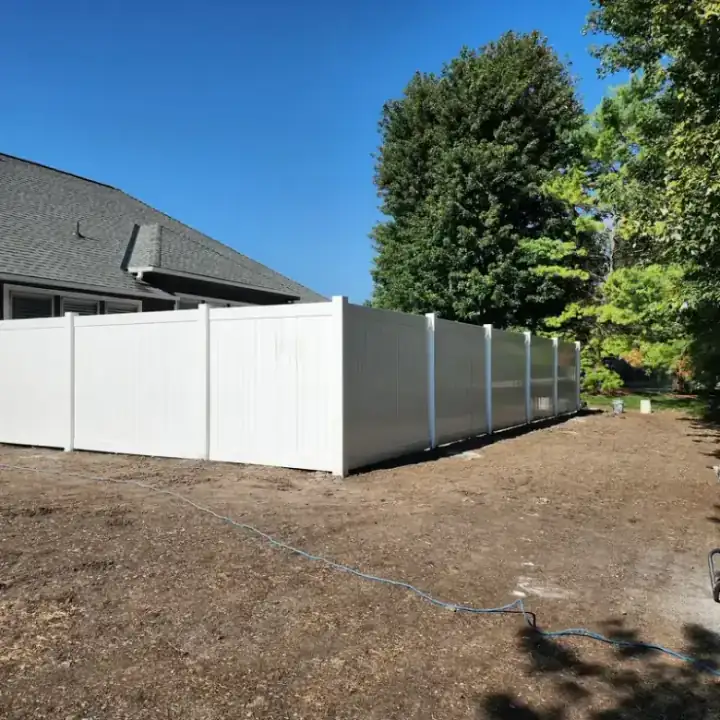 White vinyl privacy fence, a fresh install on bare dirt
