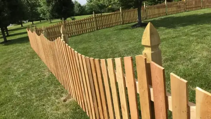Close up of scalloped picket with gothic post caps